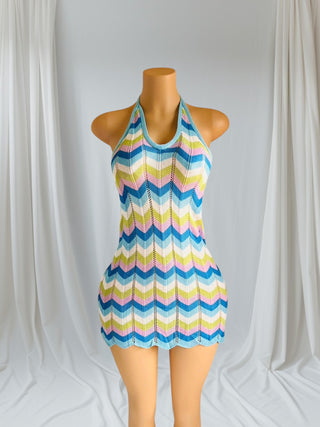 Woman wearing a colorful chevron knitted halter mini dress with open back — chic summer beach cover-up from Tulley’s Boutique.