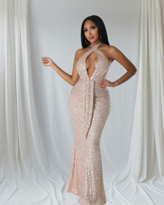 Woman wearing shimmering gold sequin halter-neck mermaid gown — Golden Elegance Gown from Tulley’s Boutique.