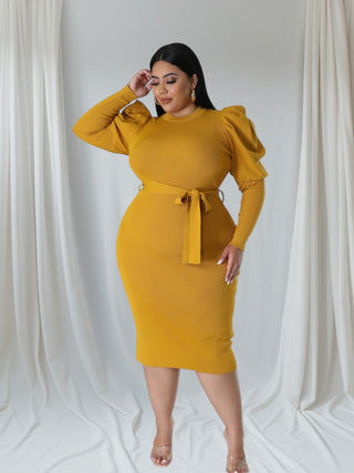Model wearing a chic mustard midi dress with puff sleeves and a belted waist, showcasing a stylish and elegant silhouette.