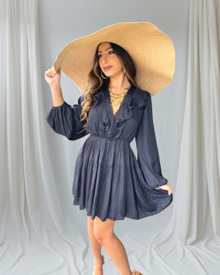 Woman wearing Let It Flow Mini Dress front view — black long-sleeve dress with flowy silhouette.