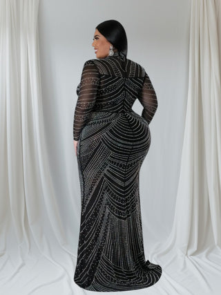 Plus-size black rhinestone mesh evening gown with mock neck and long sleeves, featuring intricate sequin detailing and bodycon fit.