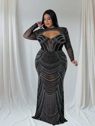 Plus-size black rhinestone mesh evening gown with mock neck and long sleeves, featuring intricate sequin detailing and bodycon fit.