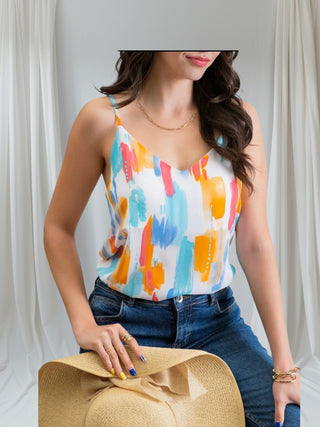 Woman wearing colorful watercolor print camisole with adjustable straps — Watercolor Dreams Cami from Tulley’s Boutique.