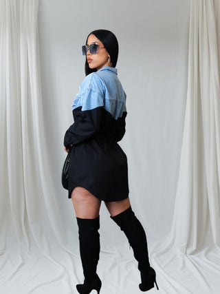 Two-tone denim and black shirt dress with long sleeves, button-up front, and drawstring waist