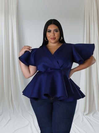 model wearing navy peplum top styled for church or conference event