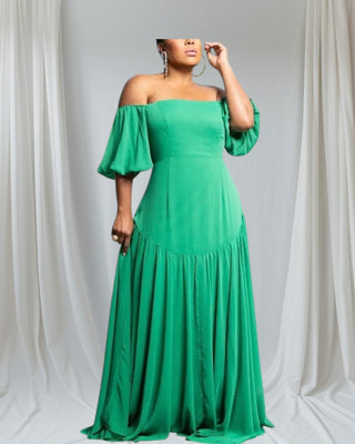 Elegant off-shoulder emerald green maxi dress with puff sleeves and tiered hem, displayed on mannequin against white background.