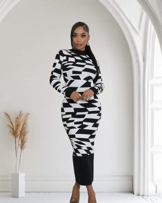Model wearing the Optical Illusion Bodycon Midi Dress featuring a bold black and white geometric pattern, with long sleeves and a form-fitting silhouette