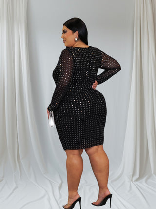 Plus-size woman wearing black long-sleeve sequin evening dress with round neckline — Tulley’s Boutique