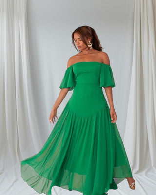 Elegant off-shoulder emerald green maxi dress with puff sleeves and tiered hem, displayed on mannequin against white background.