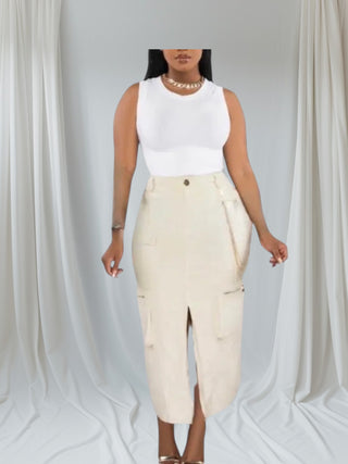 Woman wearing a cream high-rise cargo midi skirt with front slit and pockets — sophisticated utility style from Tulley’s Boutique.