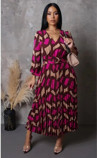 model wearing It’s My Season Maxi Dress — geometric mocha and fuchsia print with pleated skirt and belt.
