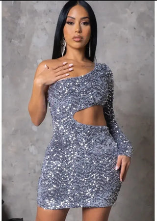 model wearing one-shoulder silver sequin mini dress with waist cut-out.