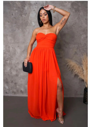 Woman wearing a strapless burnt orange maxi dress with side slit and sweetheart neckline — On My Way Maxi Dress from Tulley’s Boutiqu