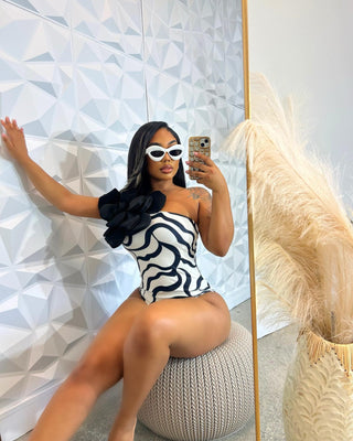 Model wearing a chic swimsuit from Tulley’s Boutique — stylish, curve-flattering design perfect for beach or poolside eleganc