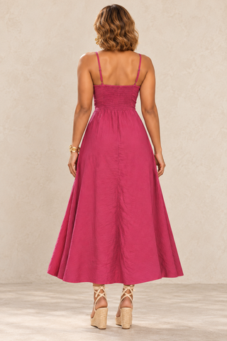 Back view of a fuchsia linen sundress with a smocked back panel and a full A-line skirt