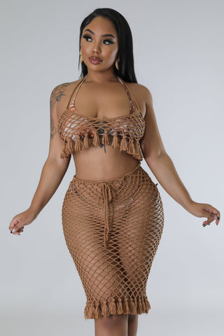 model wearing tan crochet two-piece halter top and drawstring skirt set