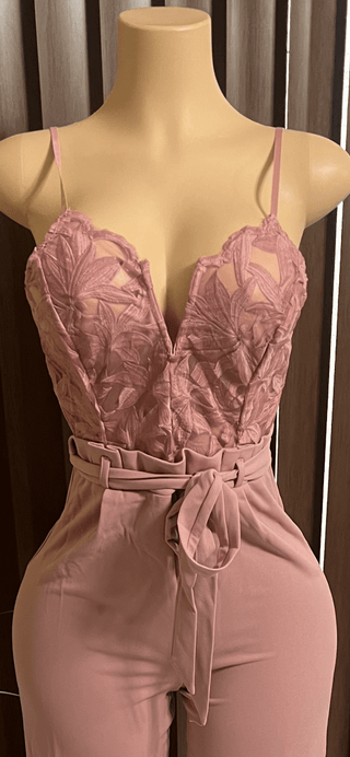 model wearing blush pink lace wide-leg jumpsuit with tie waist