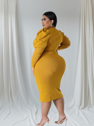 Model wearing a chic mustard midi dress with puff sleeves and a belted waist, showcasing a stylish and elegant silhouette.