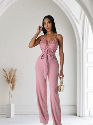 model wearing blush pink lace wide-leg jumpsuit with tie waist
