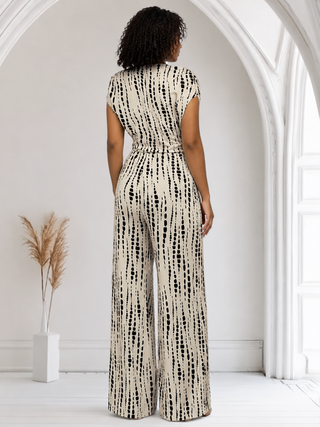 Cream tie-dye wide-leg jumpsuit with an adjustable waist tie and practical side pockets.