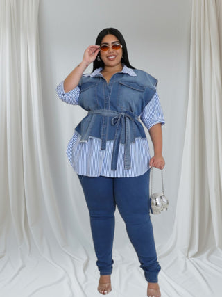 Front view of a model in a chic blue and white striped top with denim overlay and a tied waist, posing elegantly."