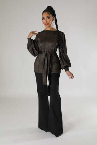 Model wearing black metallic two-piece pant set with tie-waist blouse and wide-leg pants