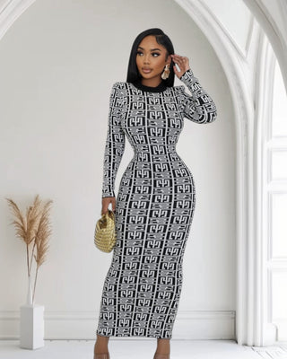 Woman wearing a black and white patterned dress, long sleeve turtleneck. body fitting