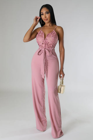 model wearing blush pink lace wide-leg jumpsuit with tie waist