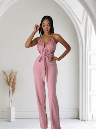 model wearing blush pink lace wide-leg jumpsuit with tie waist
