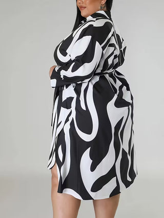 abstract black and white print, classic shirt collar, adjustable waist tie, and side slit detail.