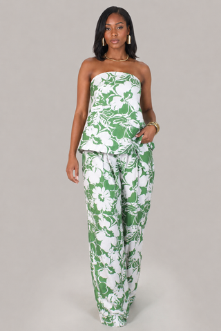 Model wearing the Palm Luxe green and white floral strapless peplum top and wide-leg pants set.