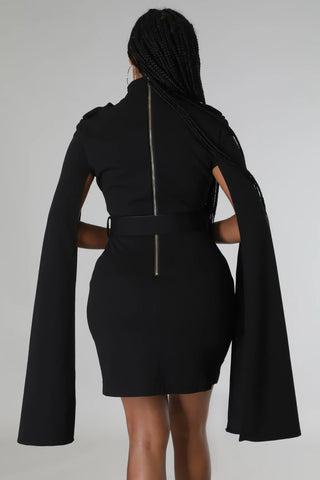 Black dress with long sleeves and cut-out design on a white background