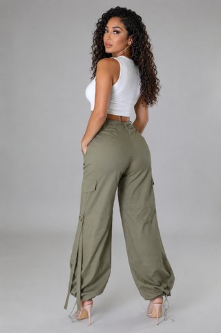 Back view of women’s olive green cargo pants with high-rise waist, relaxed legs and adjustable ankle hems