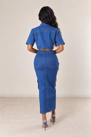 Back view of a petite denim maxi skirt showing the fitted shape and rear pockets