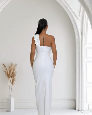 Elegant White One-Shoulder Ruffle Cutout Gown, featuring ruffle detailing, a stylish cutout at midriff, and a sultry side slit