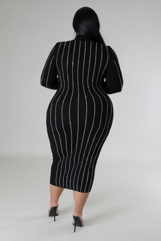 Model wearing plus-size black rhinestone bodycon midi dress with long sleeves and turtleneck