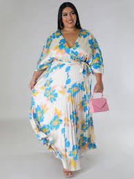 Woman wearing blue floral pleated maxi dress boutique style