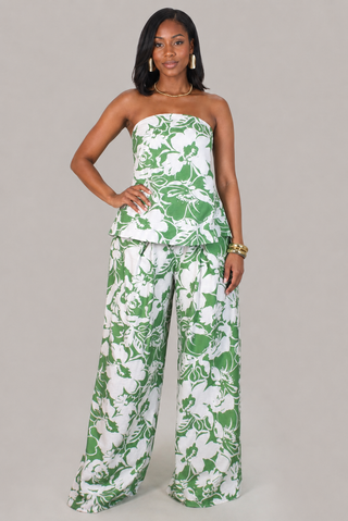 Model wearing the Palm Luxe green and white floral strapless peplum top and wide-leg pants set.