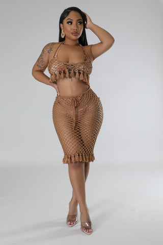 model wearing tan crochet two-piece halter top and drawstring skirt set