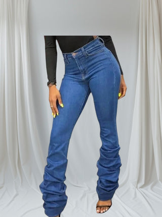 Close up of ruffle stacked hem detail on blue denim