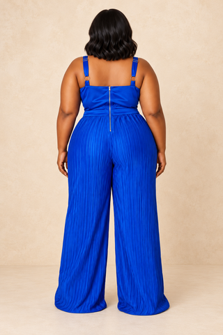 Back view of the Elegant royal blue satin jumpsuit showing adjustable straps, center back zipper, and flowing pleated wide legs