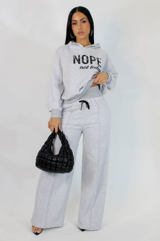 Women's gray two piece lounge set with graphic hoodie and wide leg pants boutique fashion