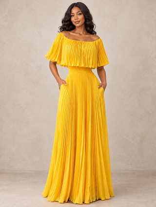 Woman in a yellow off-the-shoulder pleated maxi dress with flutter neckline, smocked waist and pockets