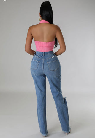 Back view of high waisted distressed denim jeans with pockets