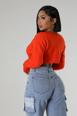 Chain front orange sweater top with high waisted jeans