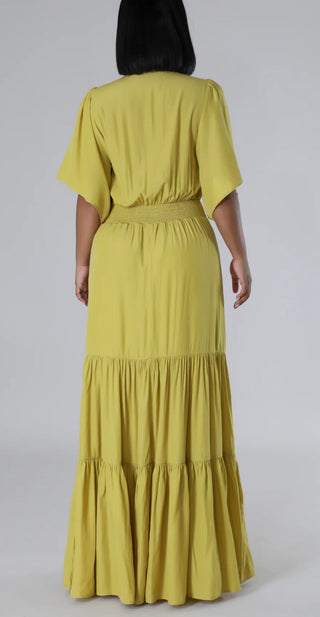 Flowy lime green boutique maxi dress with short sleeves and feminine ruched waist detail - back view