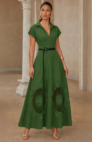 Model wearing a green collared maxi dress with a V-neck, defined waist and floral cutwork design near the hem.