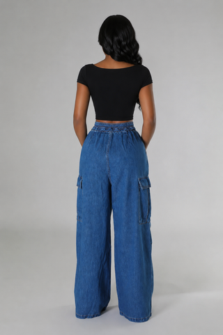 Back view of Utility Muse high-waist cargo jeans showing the elastic waistband, cargo pockets, and wide legs