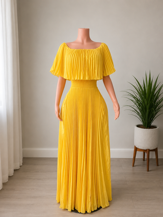 A bright yellow off-the-shoulder maxi dress with a pleated design with side pockets, displayed on a mannequin 