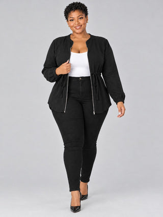 Plus size black zip-front blouse worn open like a light jacket over a white tank with black jeans